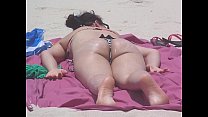 White girl in a bikini pounded on the beach