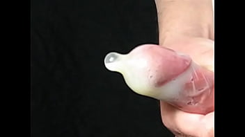 Filling a condom with much much cum.