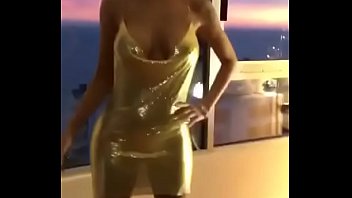 Sexy young girl is showing her sexy golden dress