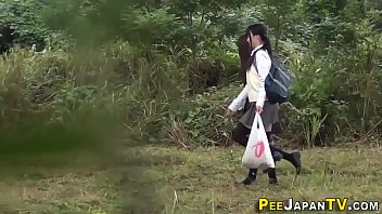 Asian teens pee outside