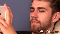 Gay jock Andrew plays on phone in solo masturbation session