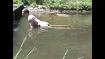 Cumming on a stone in a river