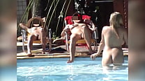 Girl ds to be using her cell phone to film a group of naked friends in the pool