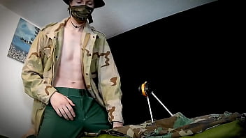Soldier milks his well hung cock behind the scenes while off duty.